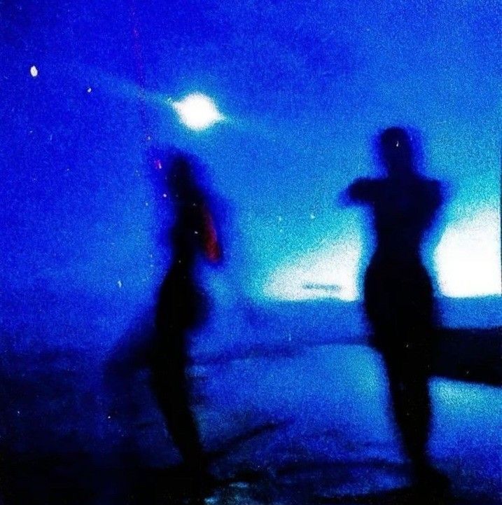 A photo of two people, blurred out.