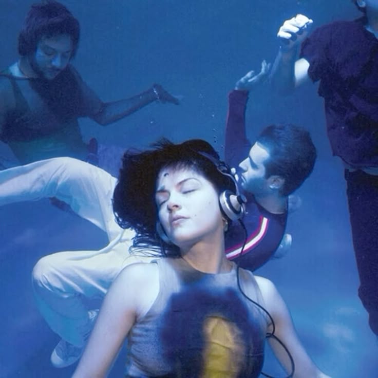 A photo of the band underwater doing poses.